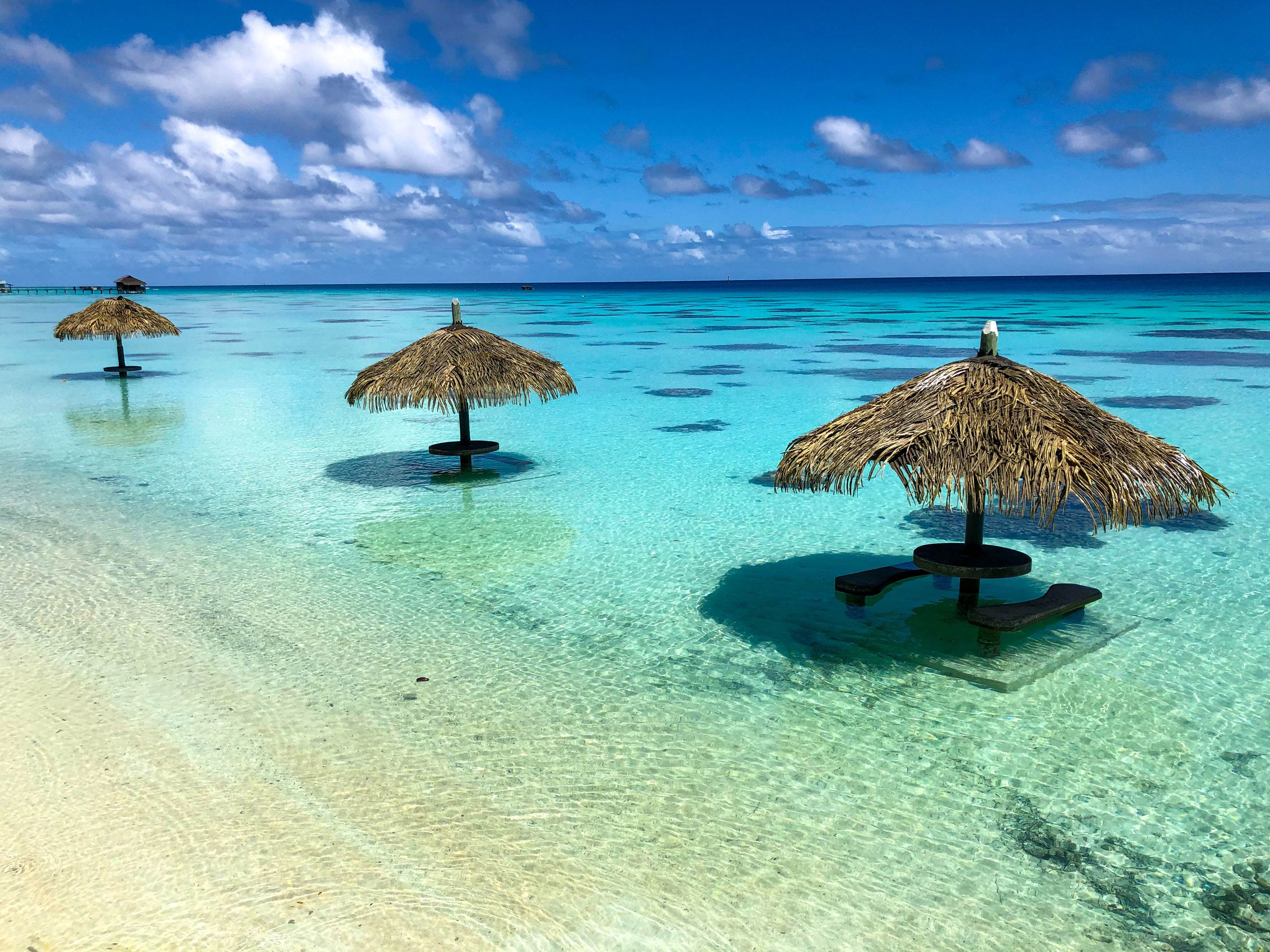 Beautiful beach umbrellas in crystal clear water
